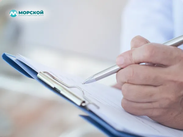 Врач пишет заключение пациента Врач пишет ручкой на листе бумаги